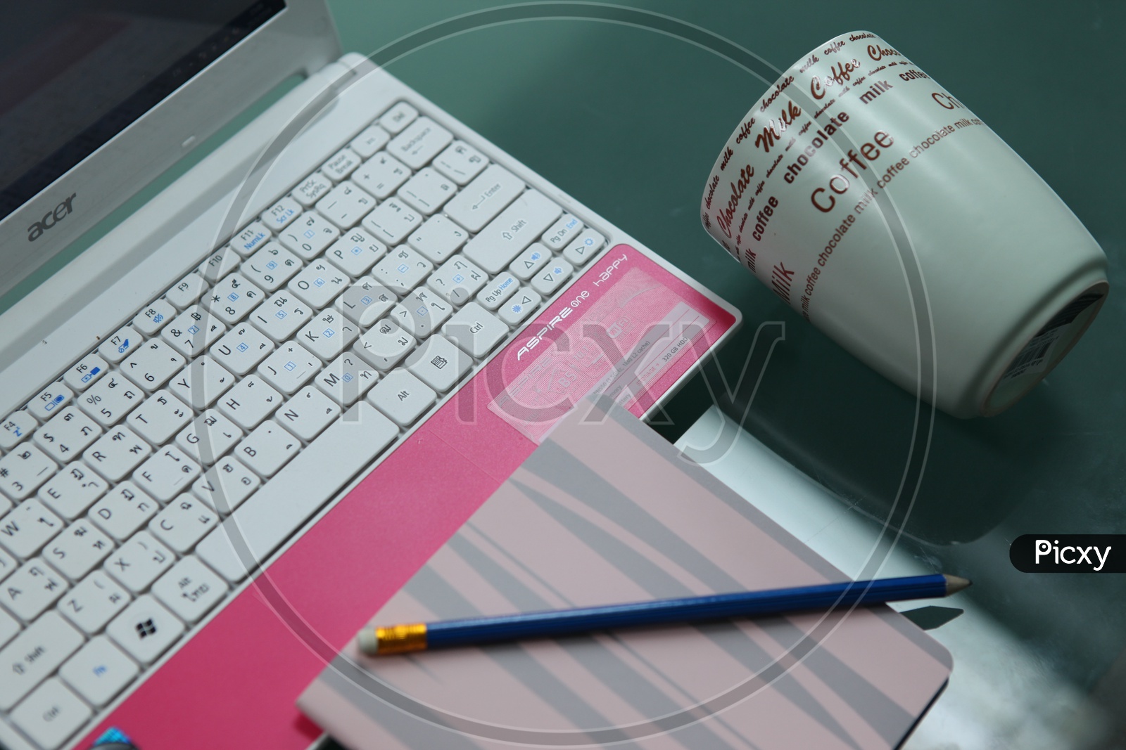 A Composition Shot Of a Working Table With Laptop , Coffee Cup  and Notebook With Pencil