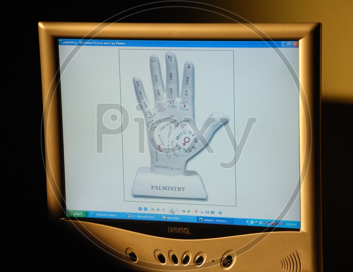 Old computer monitor showing palm readings