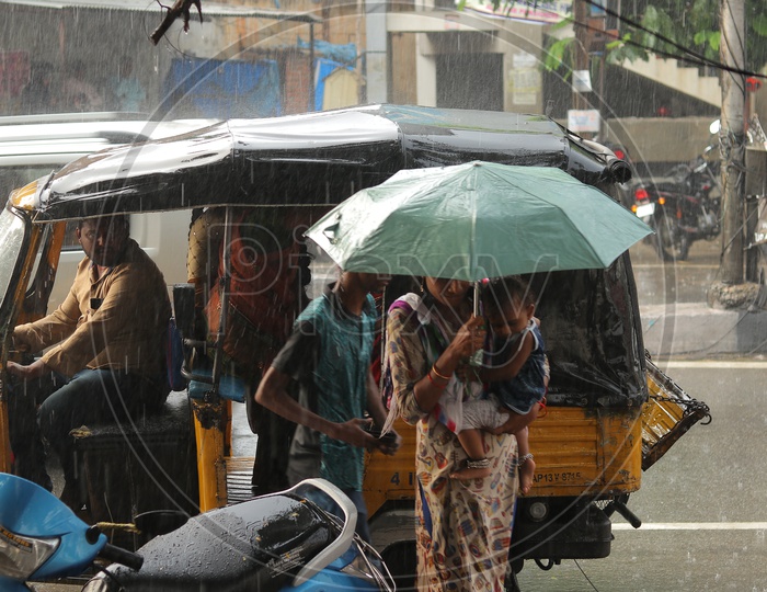 Woman carrying umbrella during the rain
