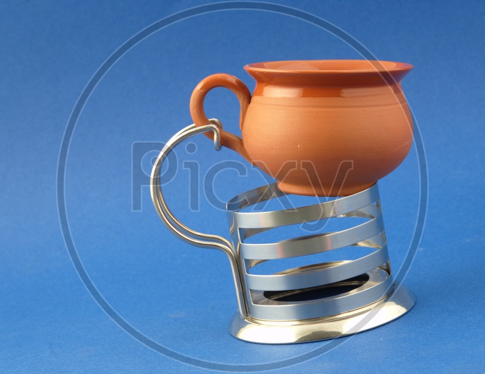A Clay Pottery  Coffee cup With a Steel Stand