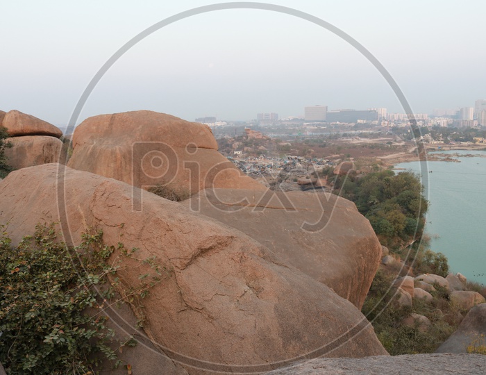 A Rock hill With Rocks and City View