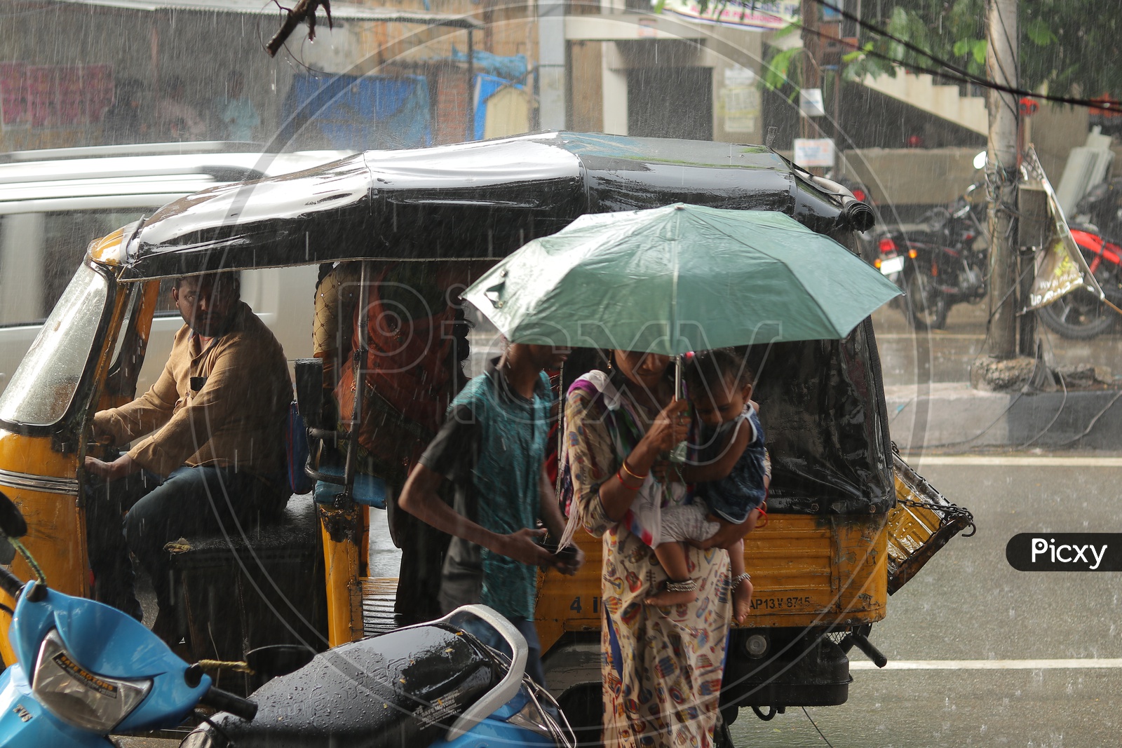 Woman carrying umbrella during the rain