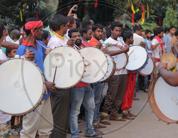 People Playing the Local Drums