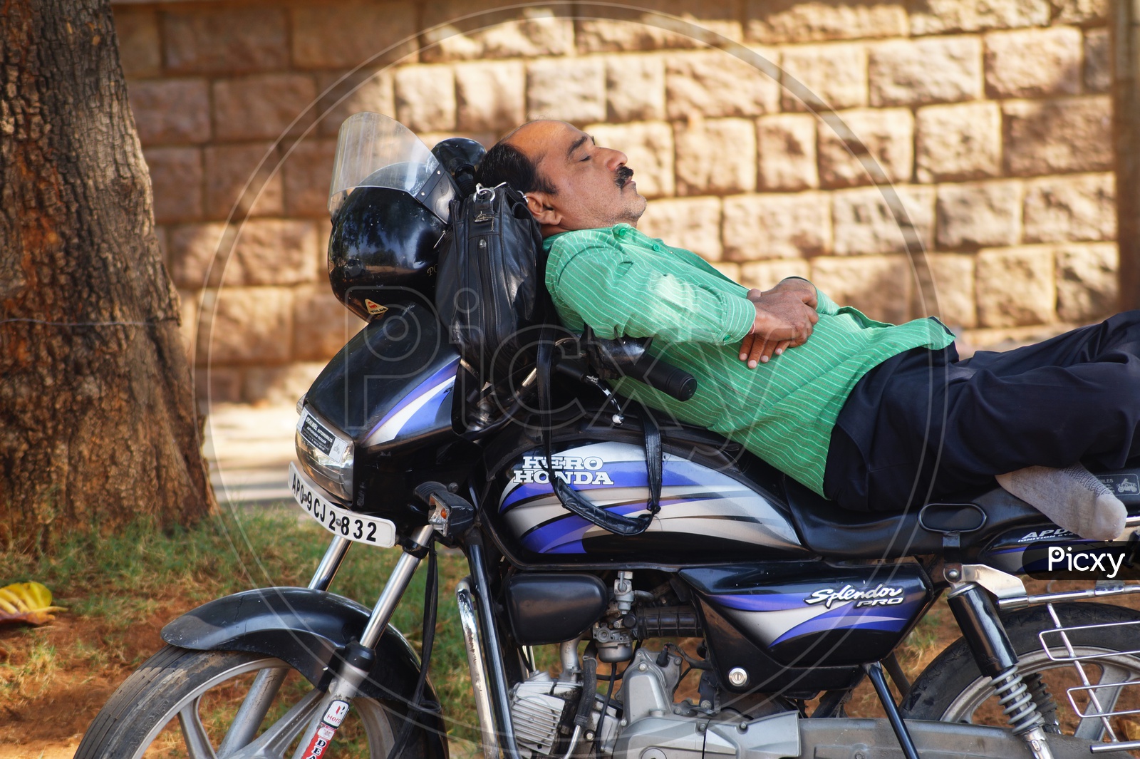 Man resting on Motorcycle