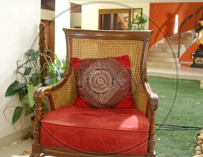 A Designed Wooden Chair With Cushion Pillow