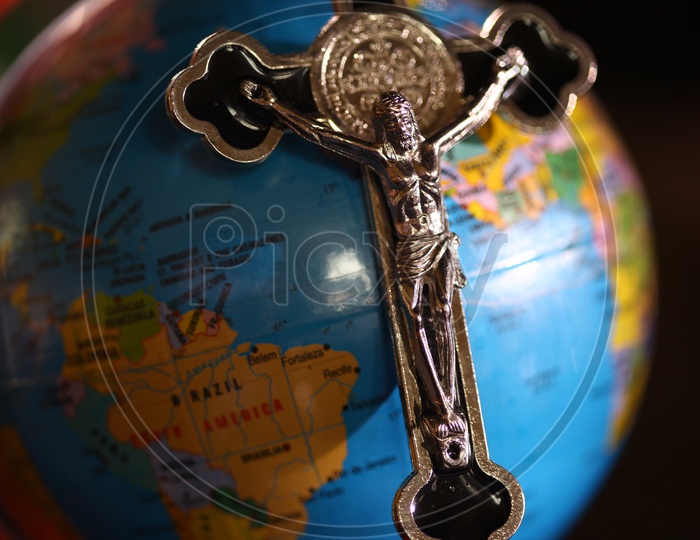 Cross Jesus Christ Christian Pendant placed on the Globe