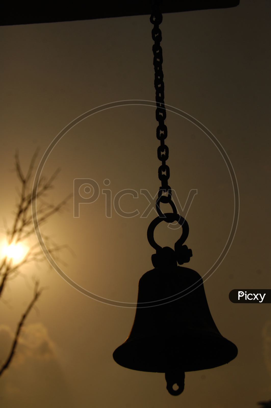 A hanging bell and a Sun in the background