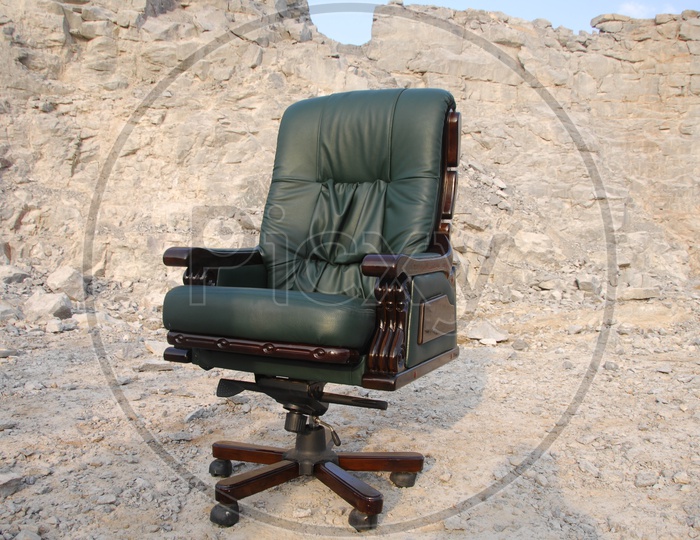 An Office Chair With Cushion over a Rock hill Background