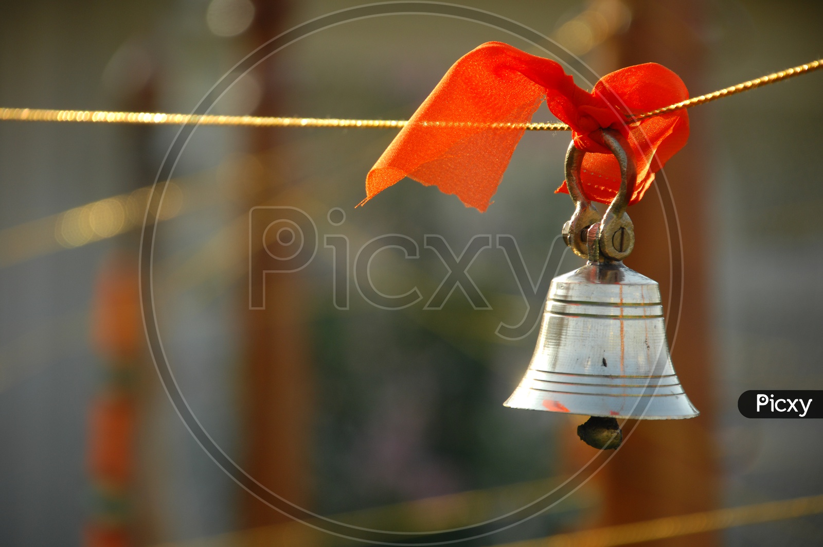 Hanging metal bell tied to a rope
