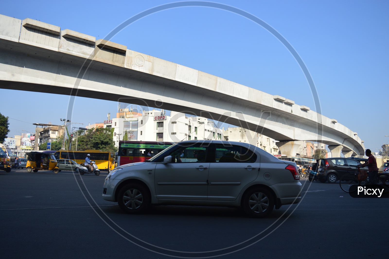 Vehicles moving on Hyderabad roads with Hyderabad metro rail  in background