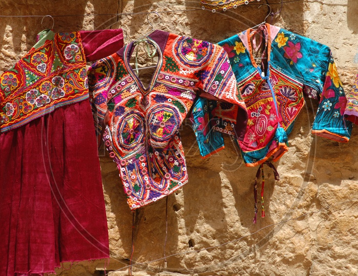 Indian Clothes Hanging To a Wall In a Vendor Stall