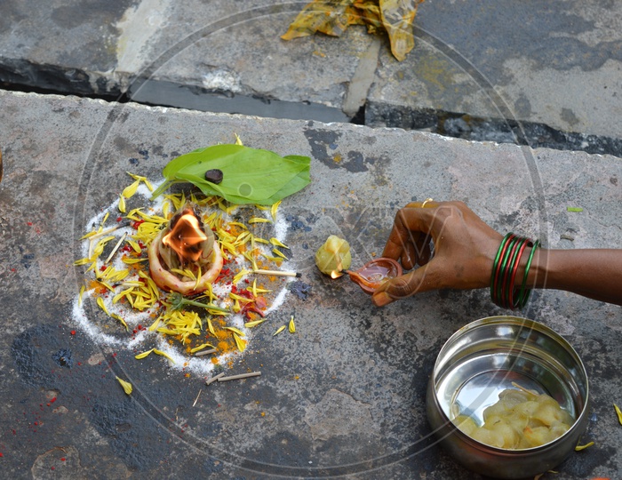 Hindu Devotees Lighting a Ghee Dias In a temple