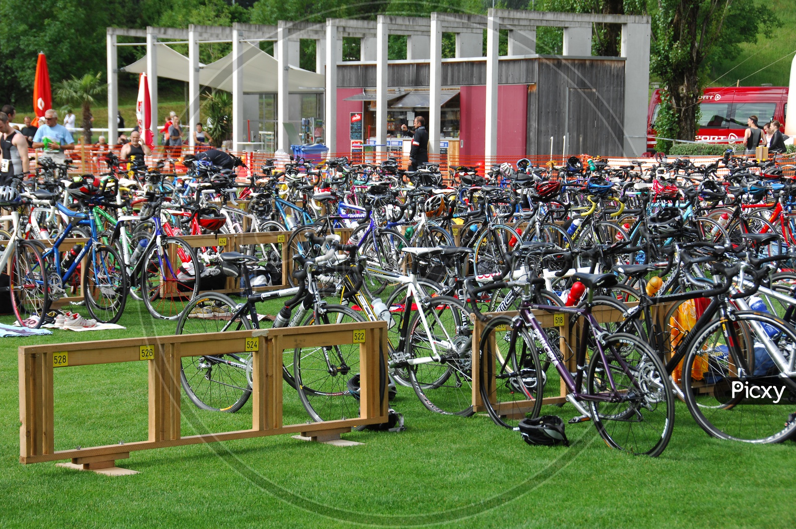 A Group of Cycles Parked In a Parking Area