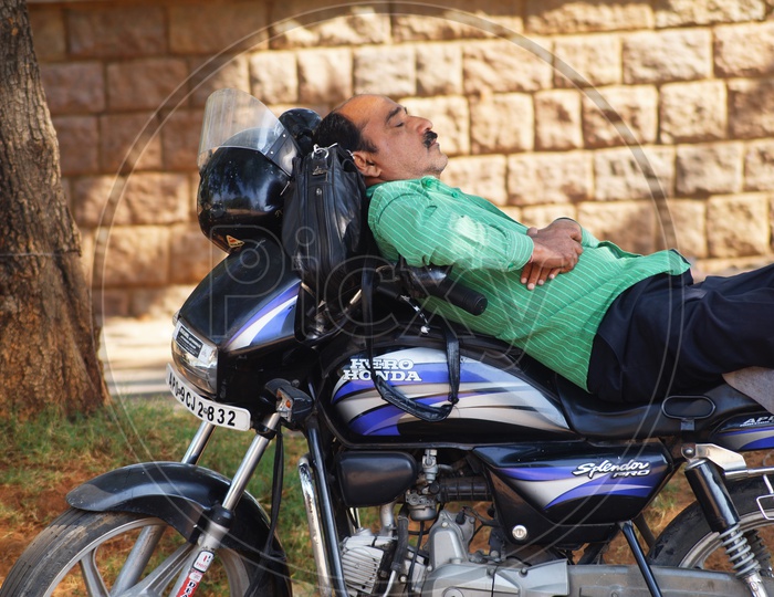 Man resting on Motorcycle