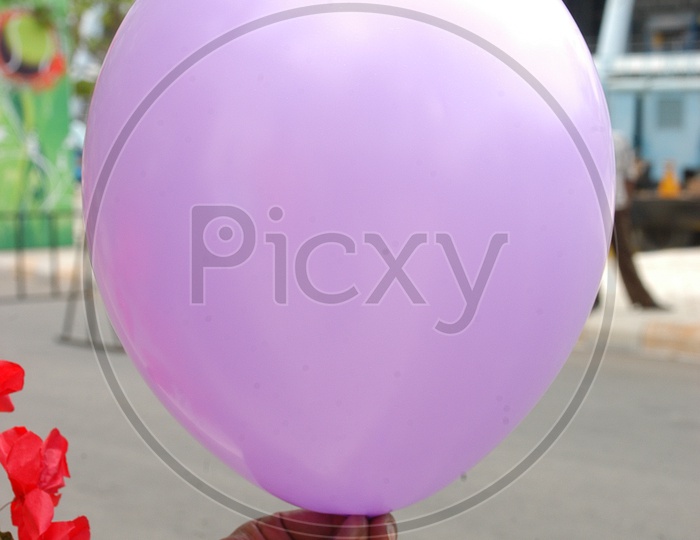 Purple balloon in hand