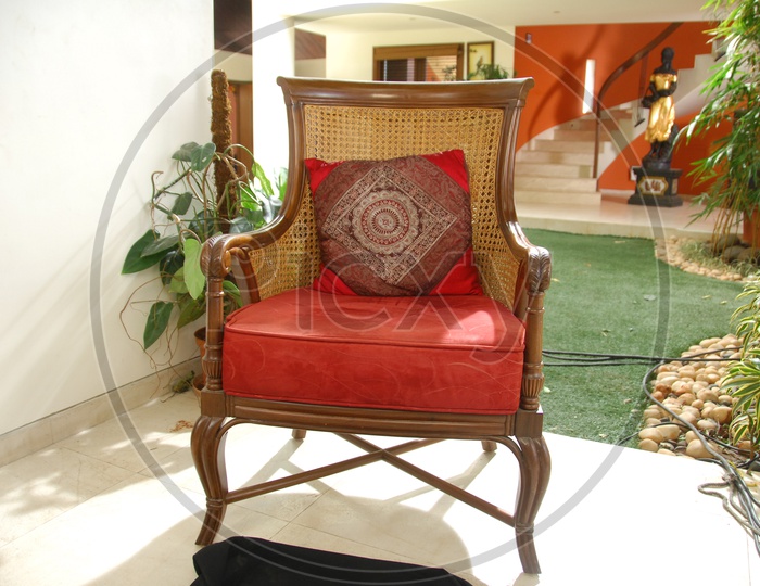 A Designed Wooden Chair With Cushion Pillow