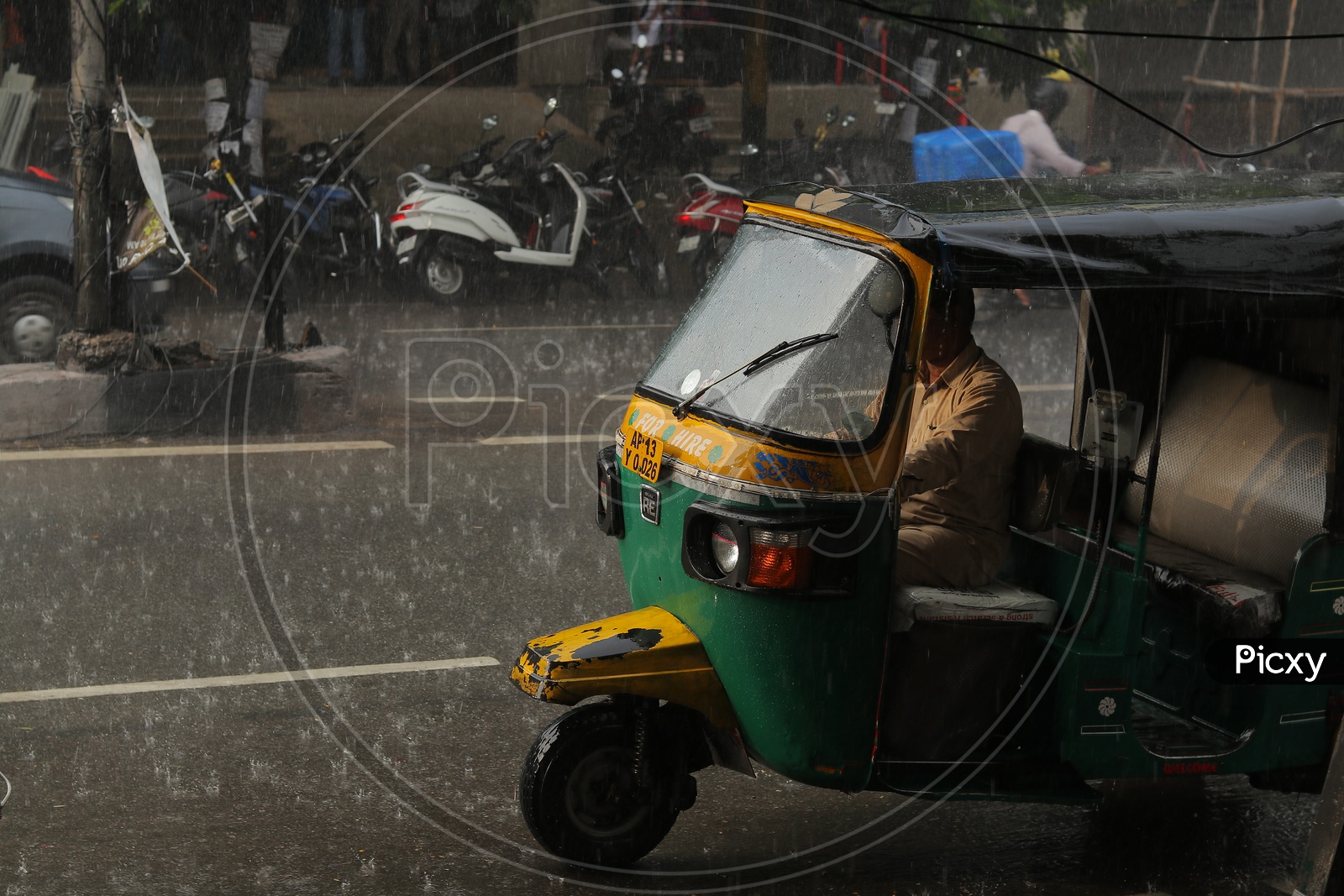 Auto moving on hyderabad roads on a rainy day