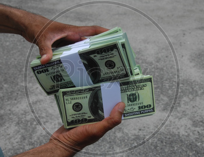 American Currency Bundles held in a Hand