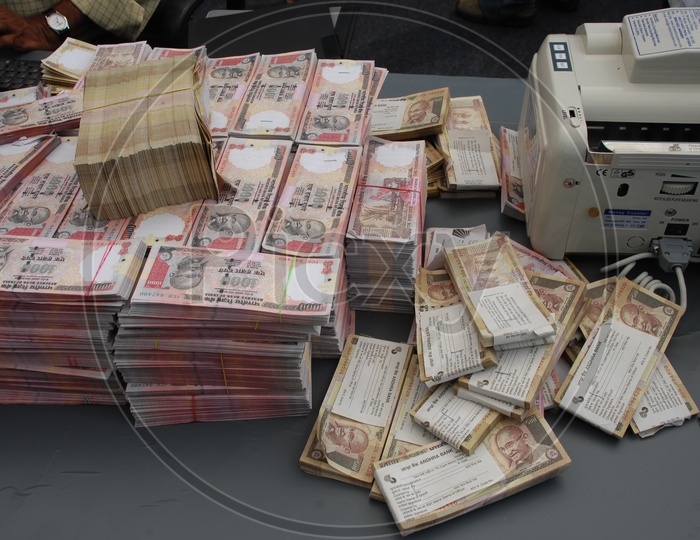 Indian Old Currency Bundles In a Office Work Space With Counting machine