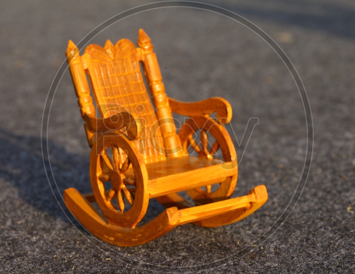 A Composition Shot Of a Wooden Swing Chair Model Toy