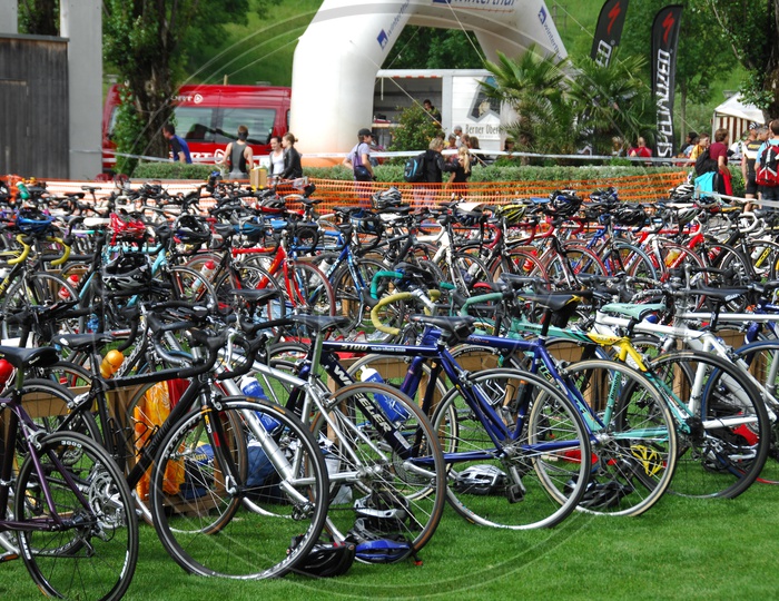 A Group of Cycles Parked In a Parking Area