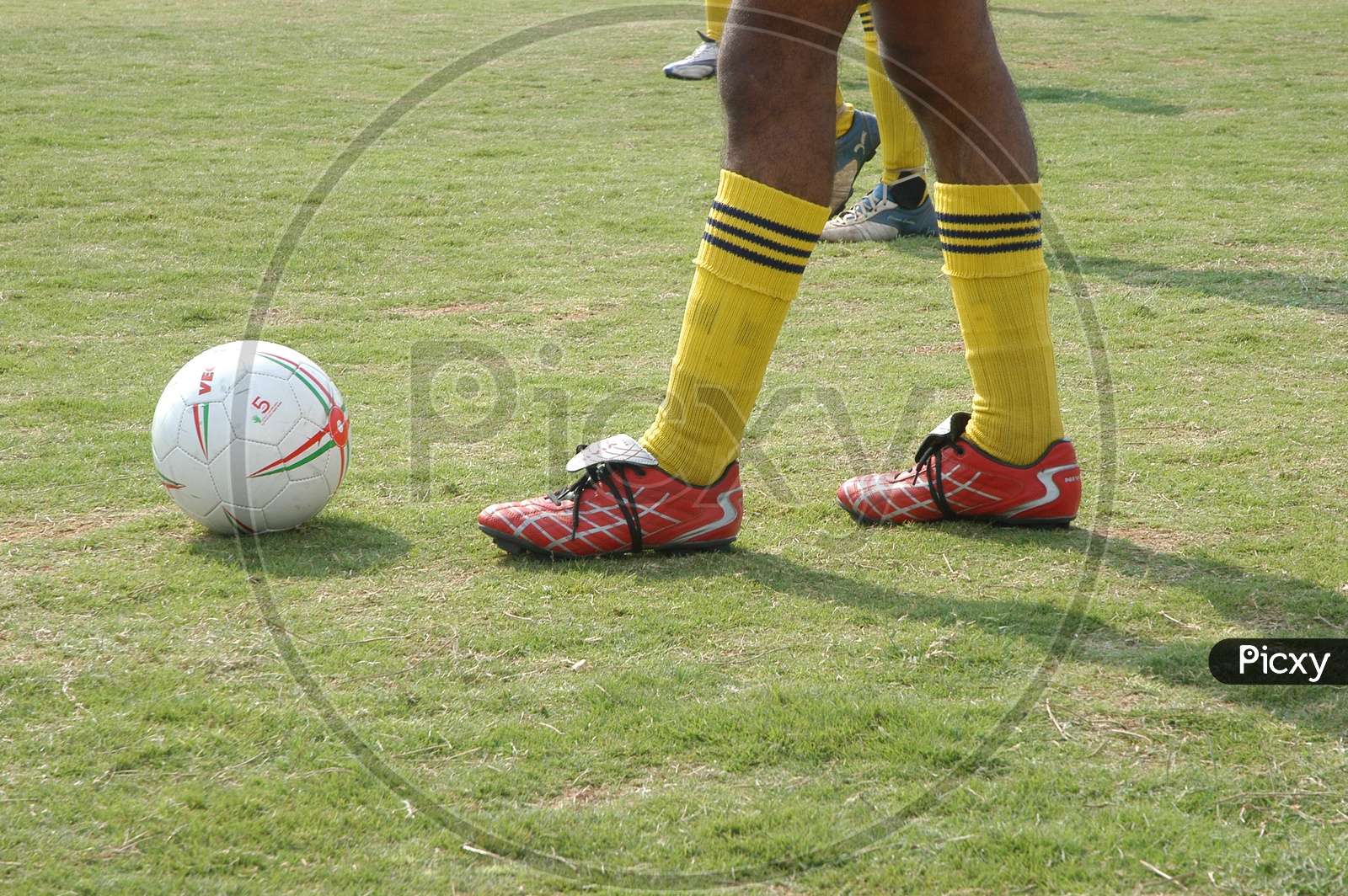 A Football Player Shoe And Ball Closeup