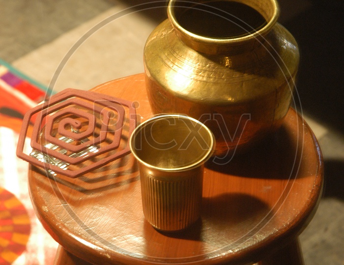 Mosquito coil alongside the brass glass and tin
