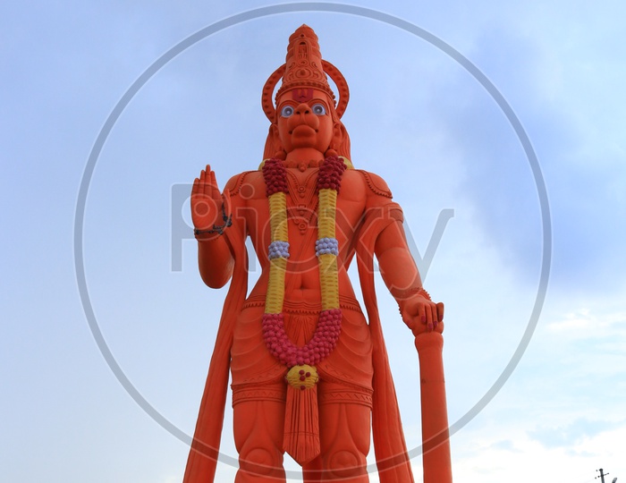 An orange coloured Hanuman statue