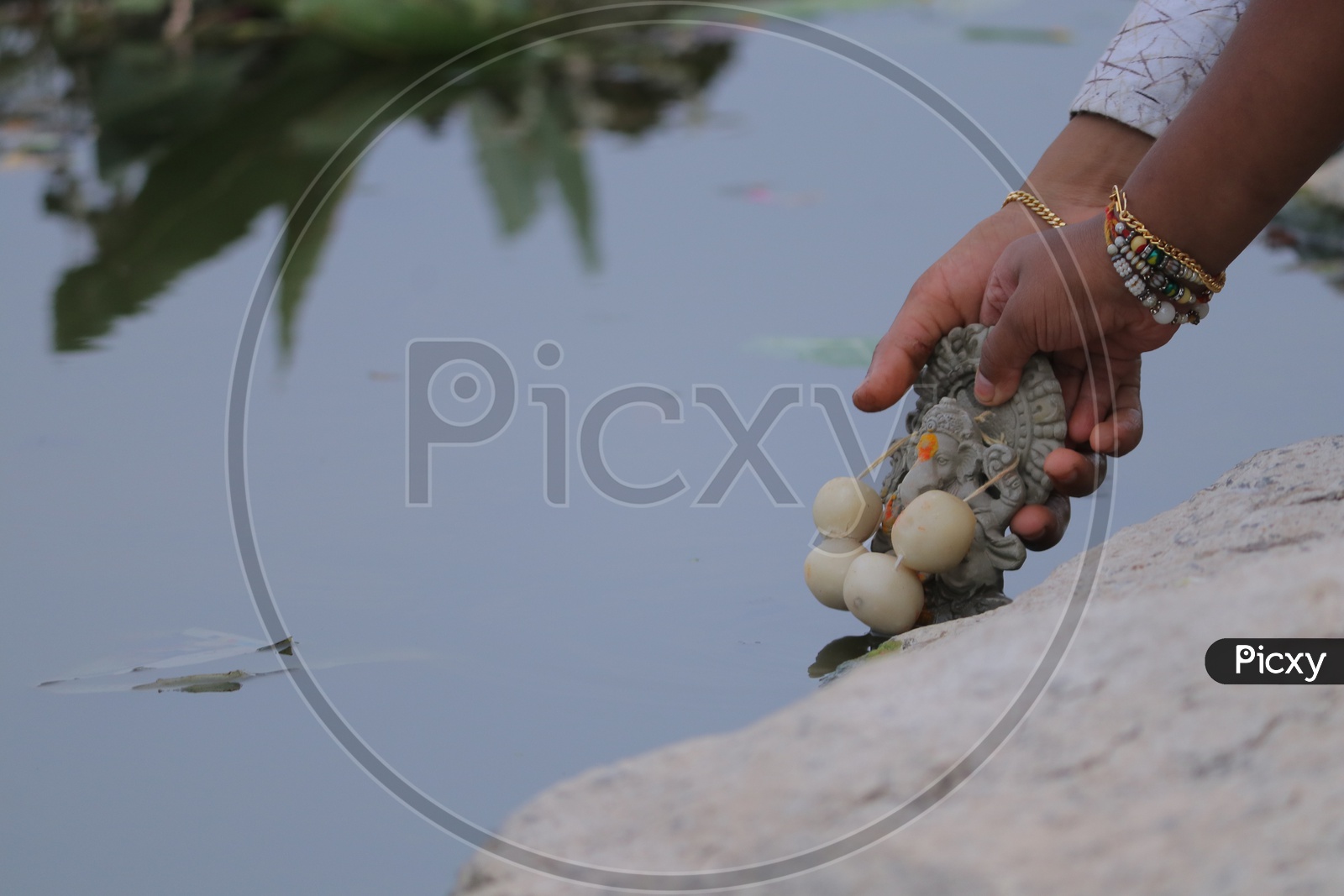Immersing clay Ganesh Idol in a lake