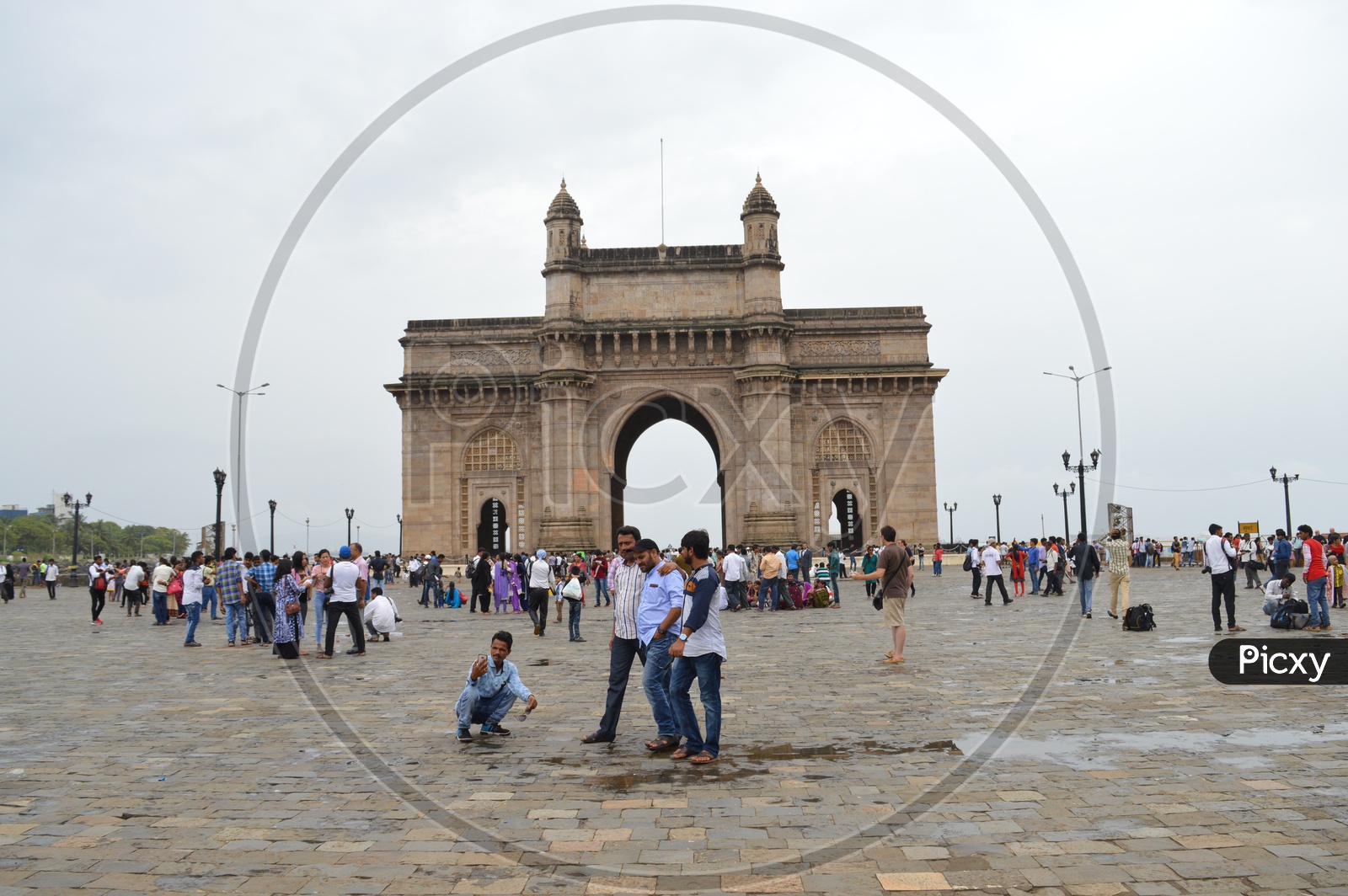 people taking pictures at gateway of india