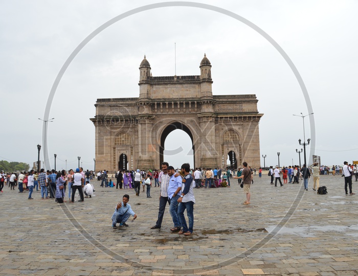 people taking pictures at gateway of india