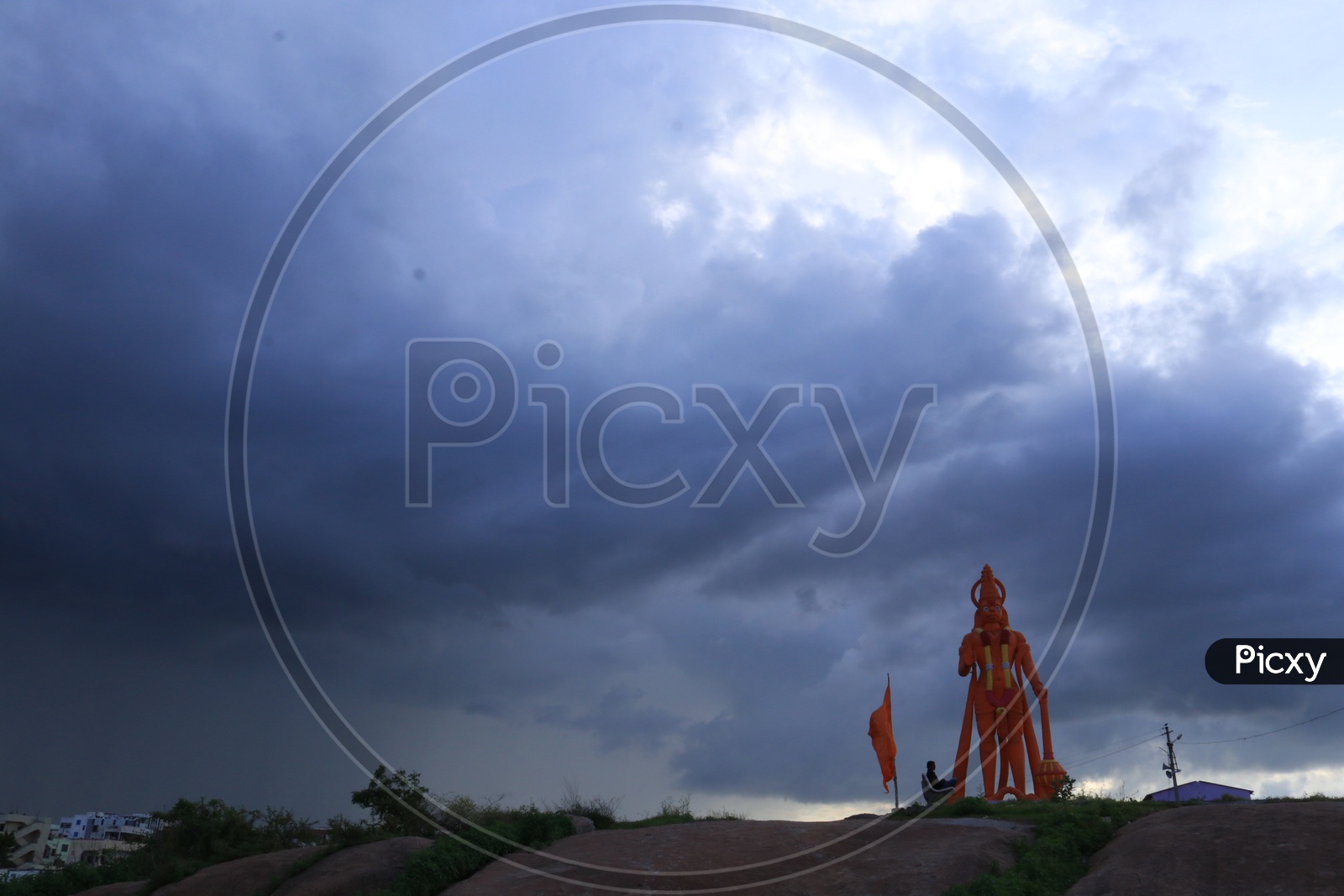 Hanuman statue with clouds in the sky