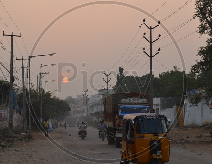 Sun Rise on a road with moving Vehicles at Toli Chowki