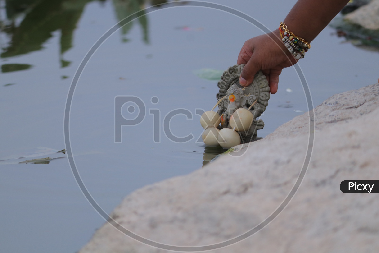 Clay Ganesh Idol immersion in a lake