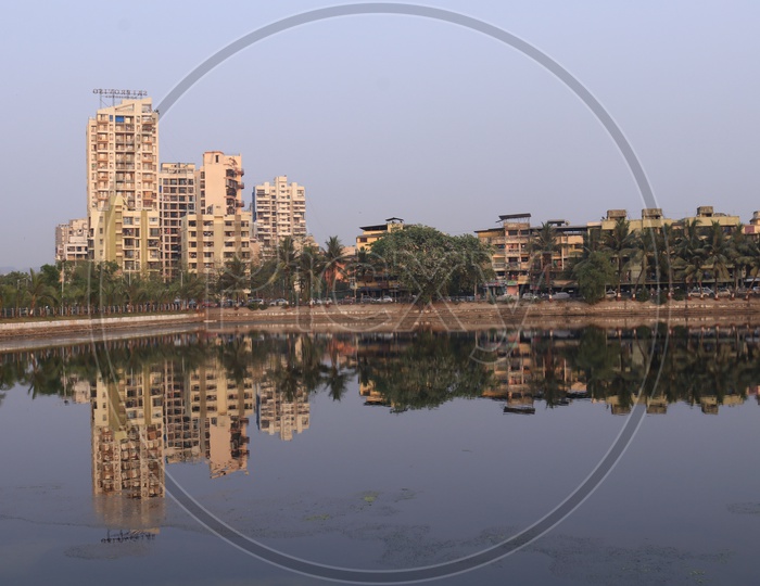 A View Of Reflection of High Rise Buildings on Water Pond