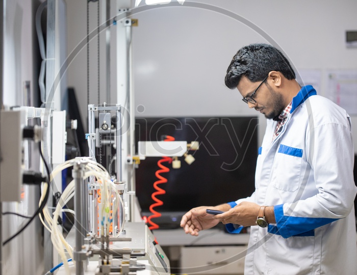 Technicians Working in a Phone manufacturing Unit Wearing Aprons