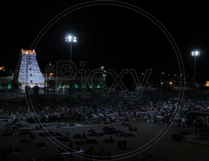 Gopuram of Tirumala with people sleeping in foreground