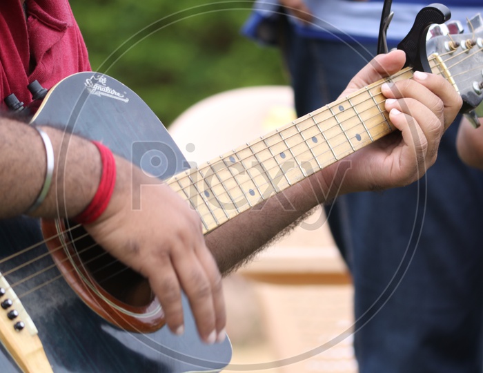 A Man Playing Guitar Closeup Shot