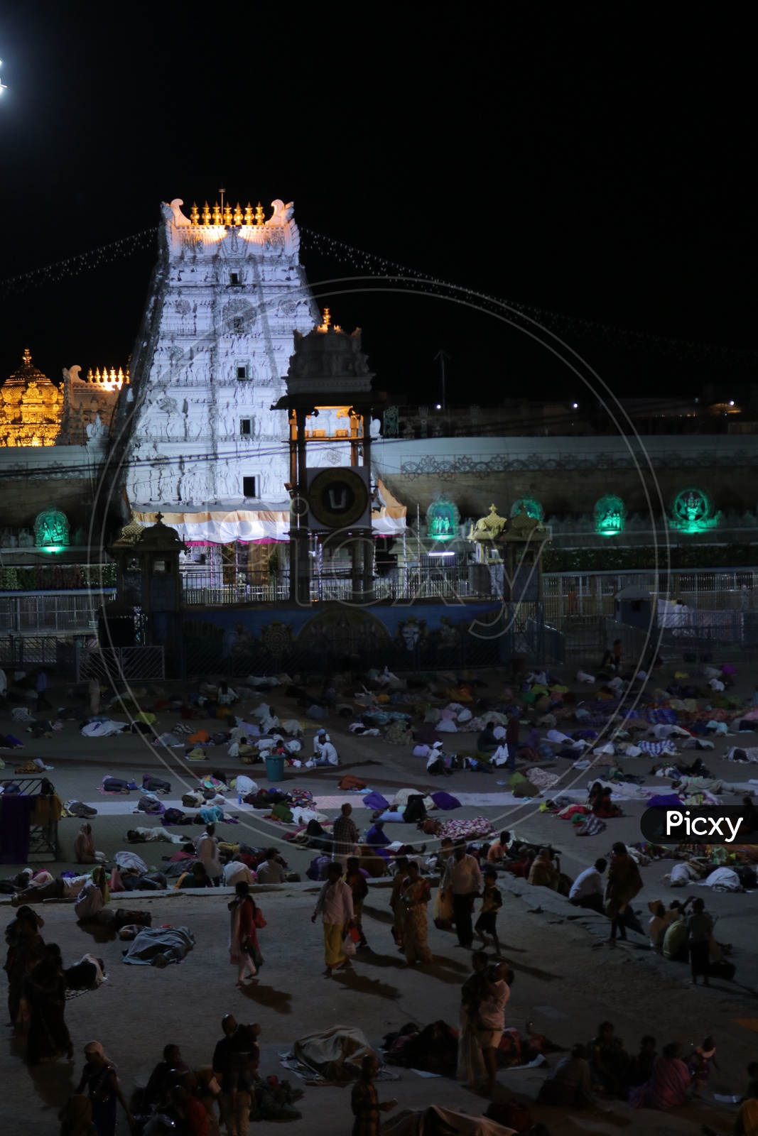 Gopuram of Tirumala with people sleeping overnight in foreground