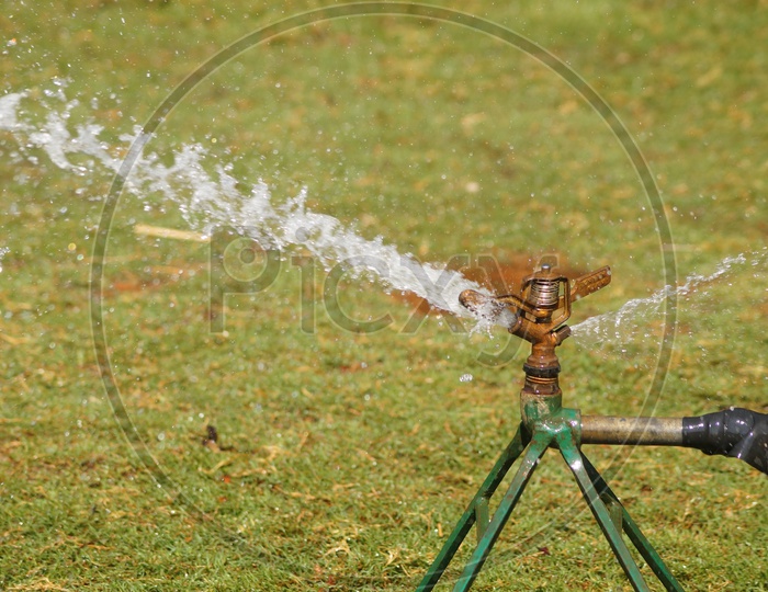 Water Sprinklers Sprinkling Water in a Garden