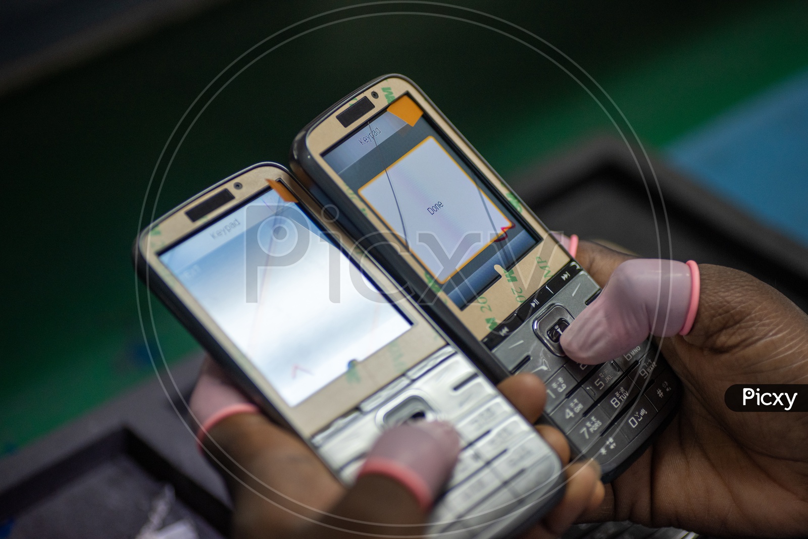 Technicians Manually Fitting the Mobile Phones in a Manufacturing Unit Hands Closeup Shots
