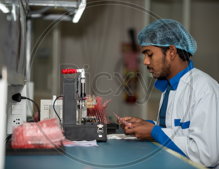 Technicians Manual Testing Of Assembled Micro Parts In a Manufacturing Unit
