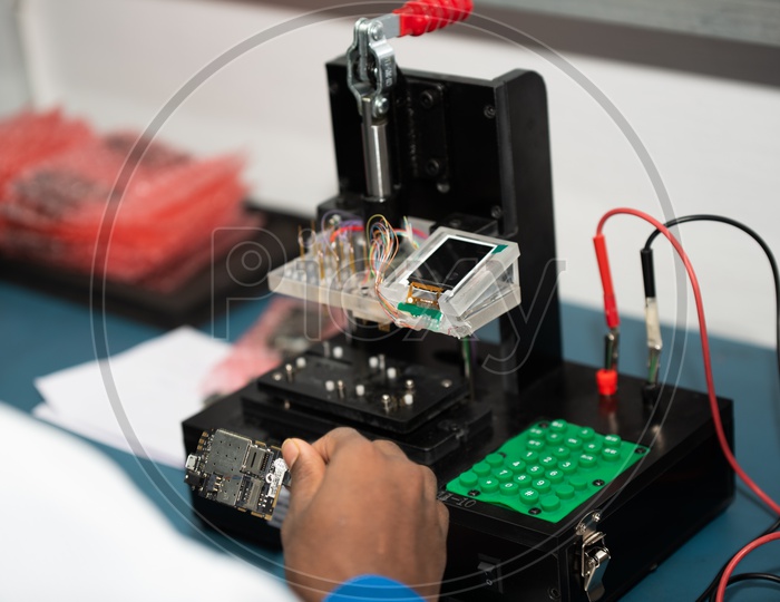 Assembled Mobile Parts   Testing in a Micro Chip (MC) Testing Rig in Mobile Manufacturing Plant