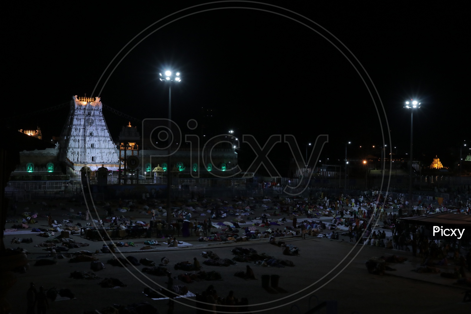 Gopuram of Tirumala with people sleeping in foreground