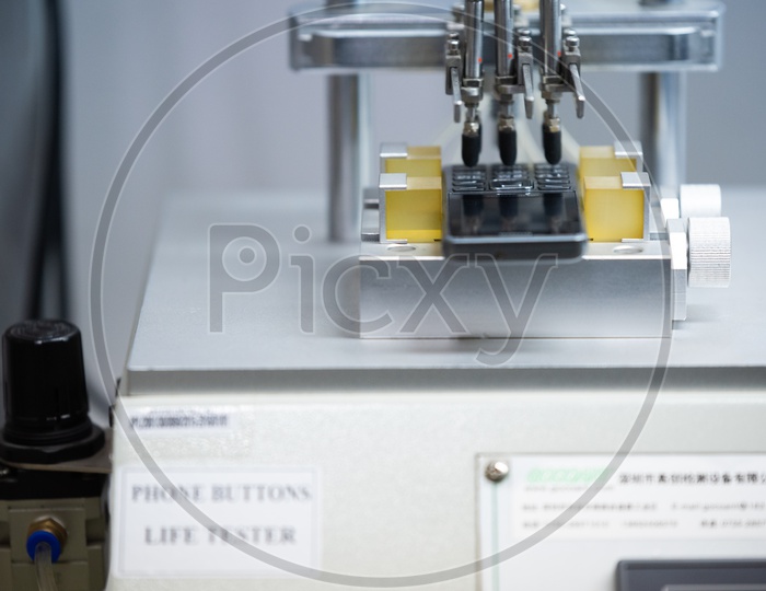Phone Buttons Life testing Machine In a Phone Manufacturing Unit