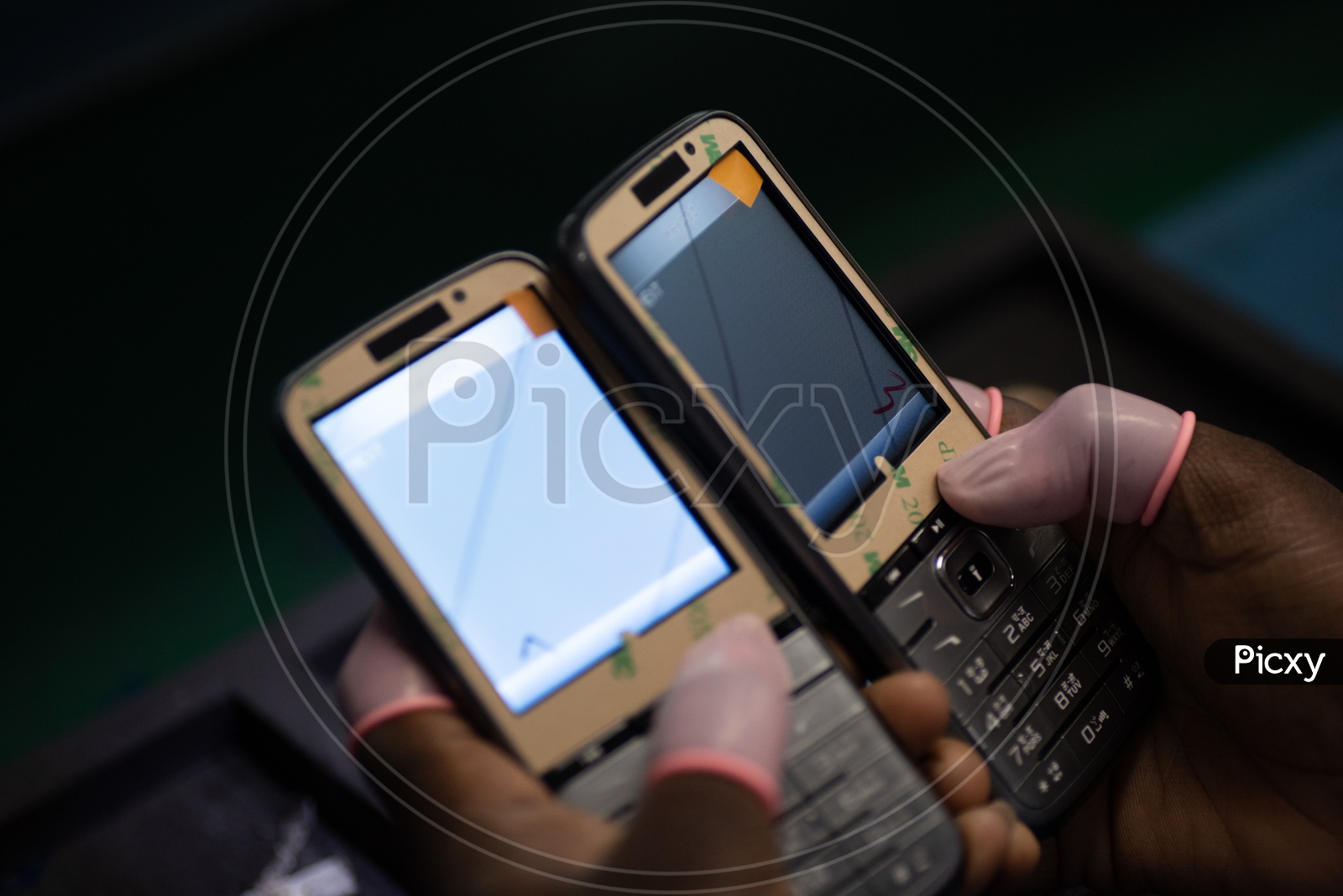 Technicians Manually Testing The Feature Phones In a Manufacturing Unit