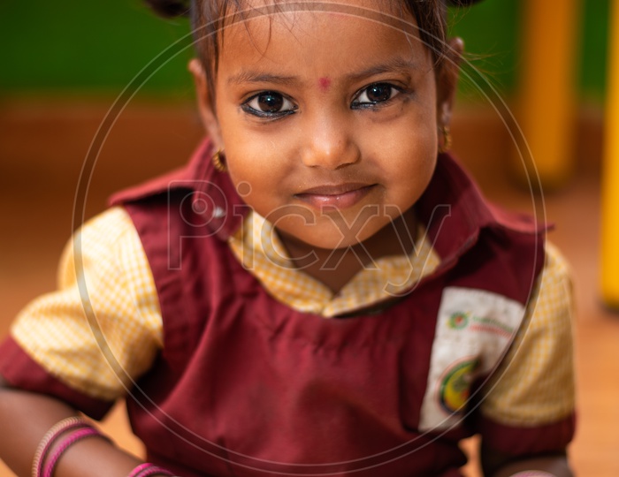 A girl student eating her mid day meal in an Anganwadi center