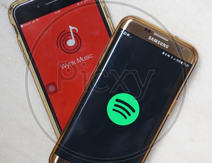 Smartphone with Wynk Music and Spotify applications on Screen