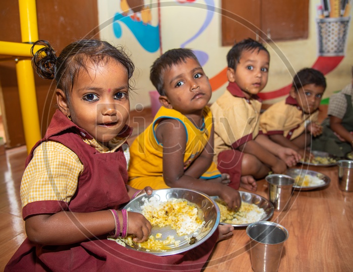 Students eating their mid day meal in an Anganwadi center