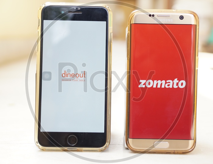 Smartphone with Dineout  and Zomato applications on Screen